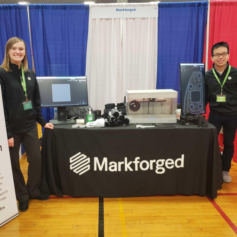Picture of two Markforged engineers at a tradeshow event